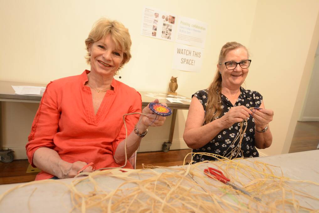 Collaboration: Lynne Barnes and Faye Collier during the first week of the community weaving project underway at the Manning Regional Art Gallery, which continues this Saturday. Photo: Scott Calvin.