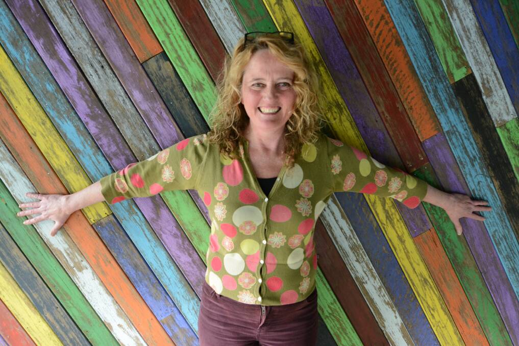 Jane Hosking with the Armadillo's carefully curated rainbow wall.