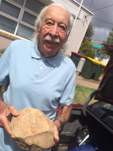Elands resident Walt Edwards with the rock the damaged his car on the Bulga Road. He says regular safety inspections should be carried out on the road.