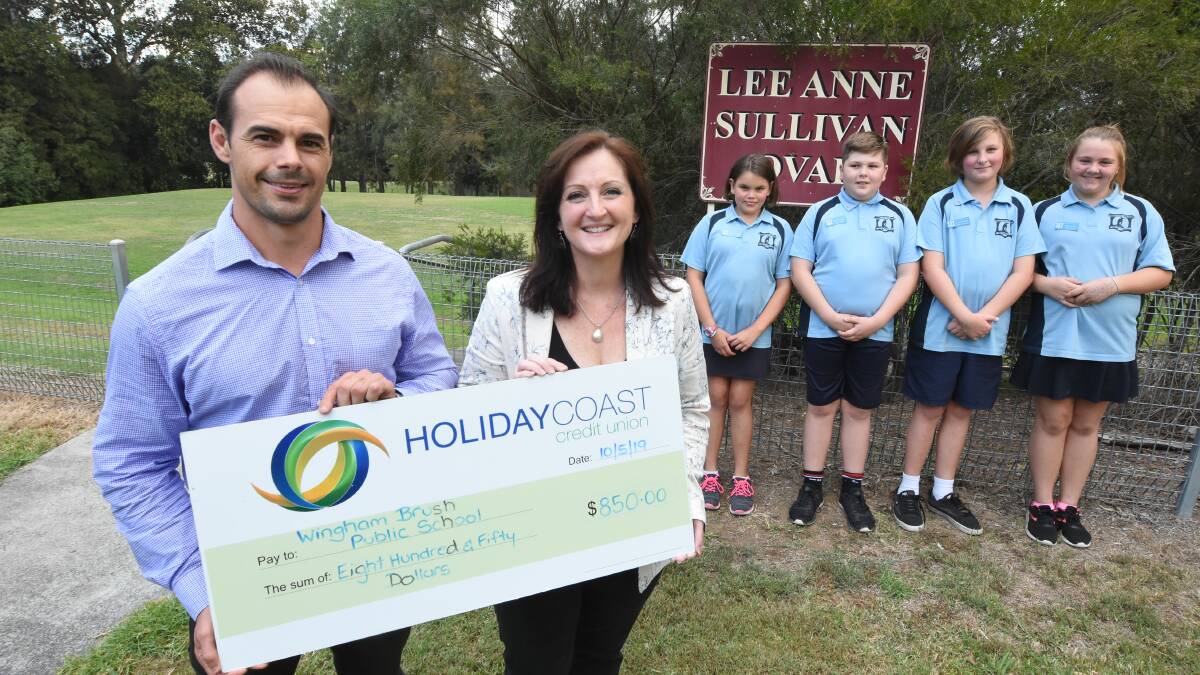 Wingham coach Mick Sullivan makes the donation to Wingham Brush principal Kylie Seaman. Students Lilli Urquhart, Johah Hurrell, Dillon Kennewell and Kiah Hughes are in the background.