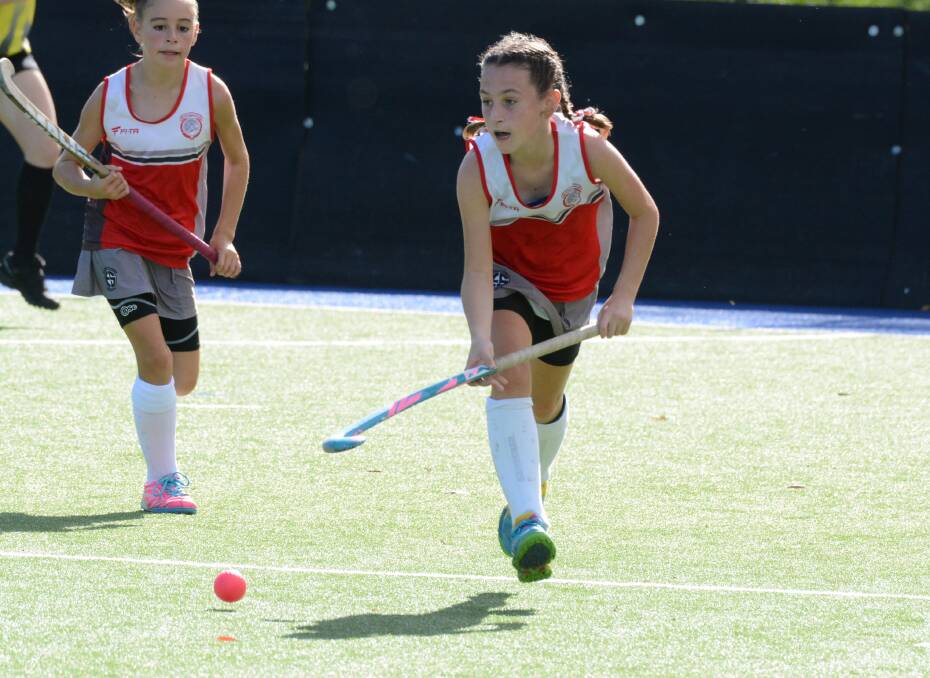Lara Whatson makes a break for Manning in the NSW under 13 girl's hockey championships played at Taree in July. 