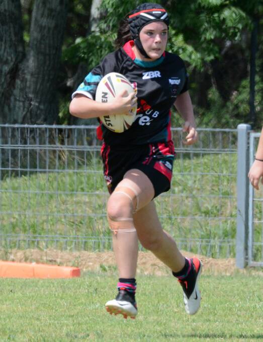 Kedilee Fletcher makes a run for Taree Panthers in a Mid North Coast 11-a-side women's rugby league game played at Taree on Saturday November 14.