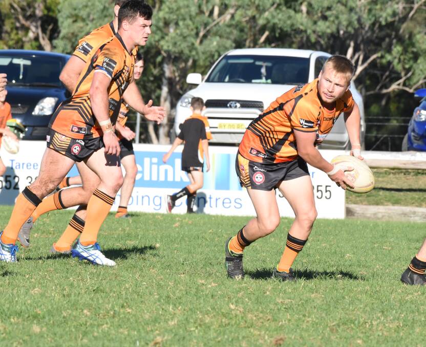 Wingham hooker Mitch Collins looks for support.
