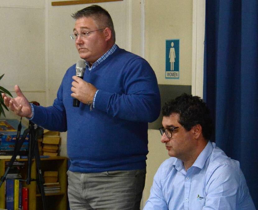 Apologetic: MidCoast Council director, liveable communities Paul de Szell and general manager Adrian Panuccio address a public meeting earlier this month.