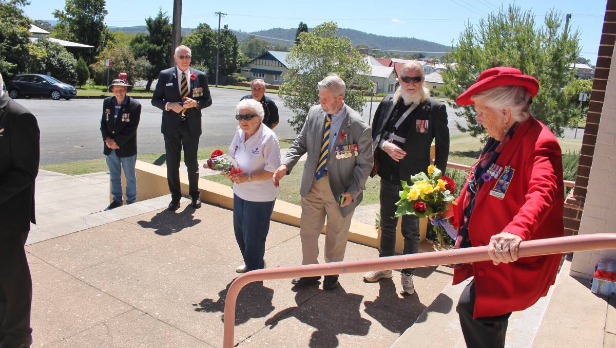Sub-branch members Brian Willey and John Muxlow behind, Red Cross representative Norieda Fotheringham, Ron Irwin, Terry Keegan and Von Hobson prepare to lay wreaths at the Wingham cenotaph.