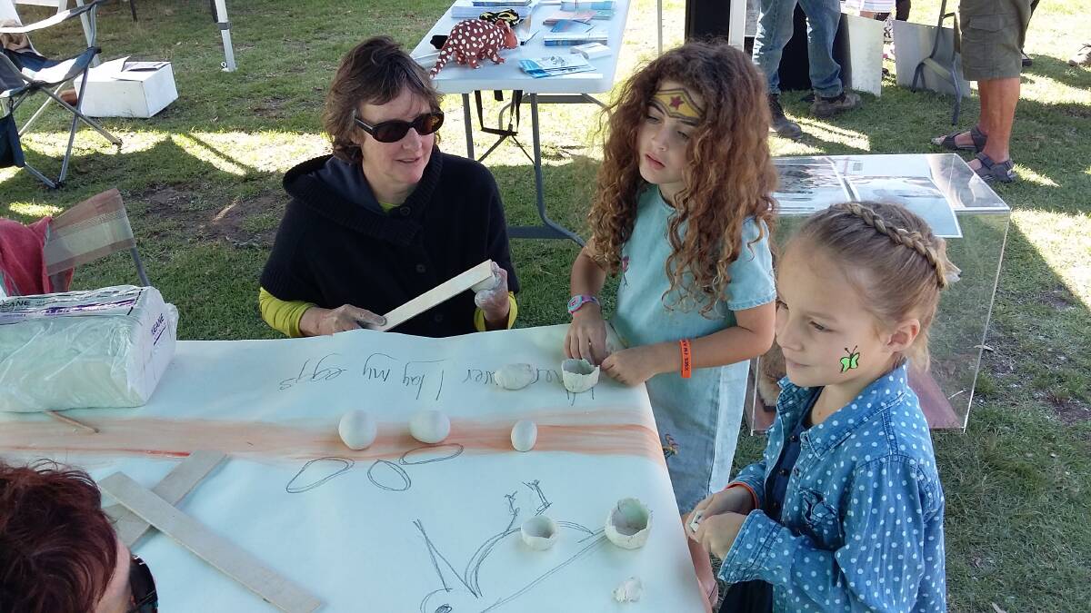 Threatened species artist Bridget Nicholson making clay eggs with Laikey and Zali at Old Bar Festival 2018. Photo NPWS
