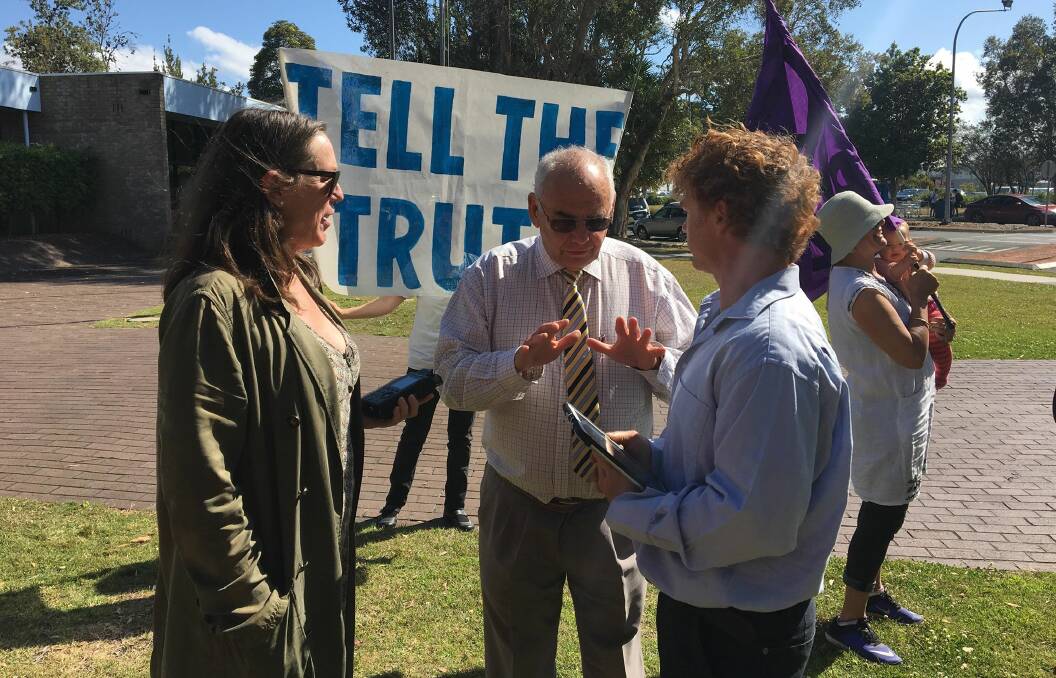 Peter Mathison speaking with MidCoast Council's Cr Len Roberts and 2BOB Radio's Rosie Herberte during a climate protest before the August 29 council meeting.