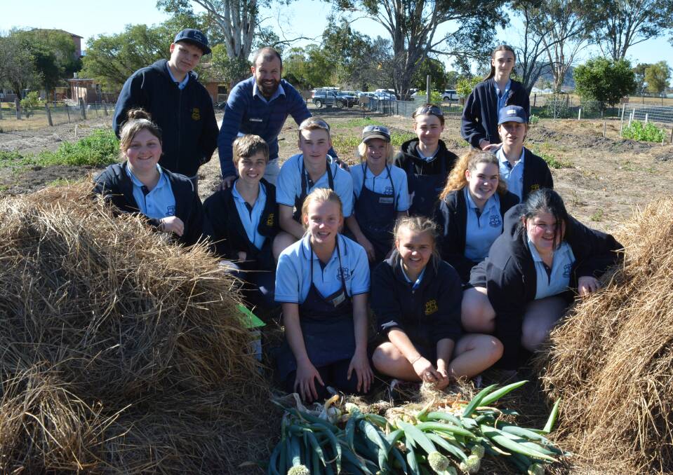 Year eight students and teach Rob Seale learn the value of recycling food scraps. 