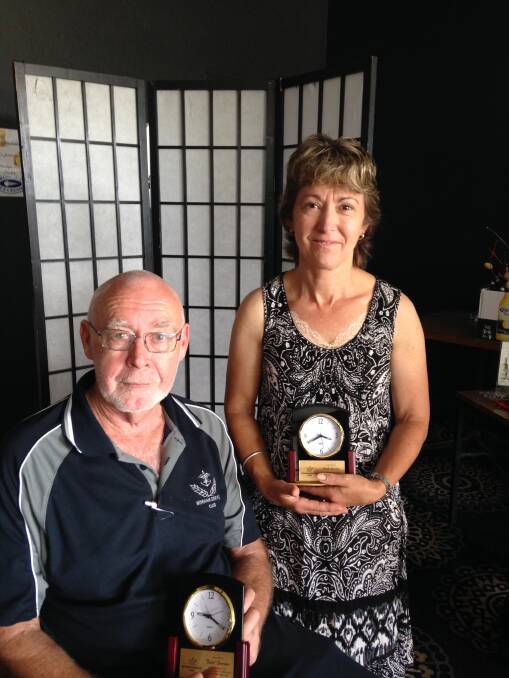 Butch Berriman and Nicole Wenham with the clocks they were awarded for a combined total of 70 years service to the Wingham Memorial Services Club. 