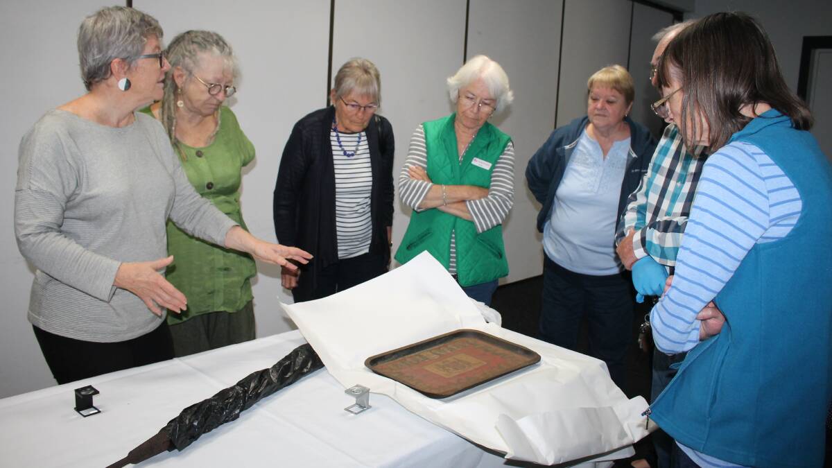 Museums Australia Guest Speaker Kay Sonderland discussing conservation of a metal souvenir tray from the Kempsey area with attendees at the workshop held at Port Macquarie. Photo: Pam Muxlow