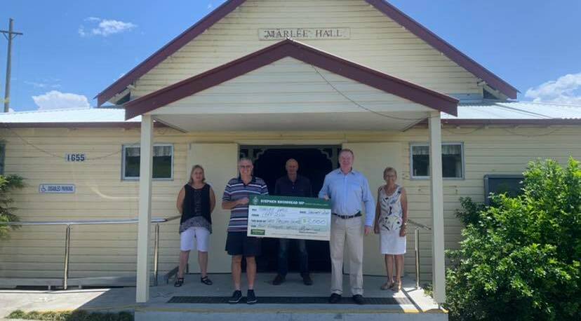 Community building: Member for Lyne Stephen Bromhead presents a cheque to volunteers at Marlee Hall. Photo: Stephen Bromhead