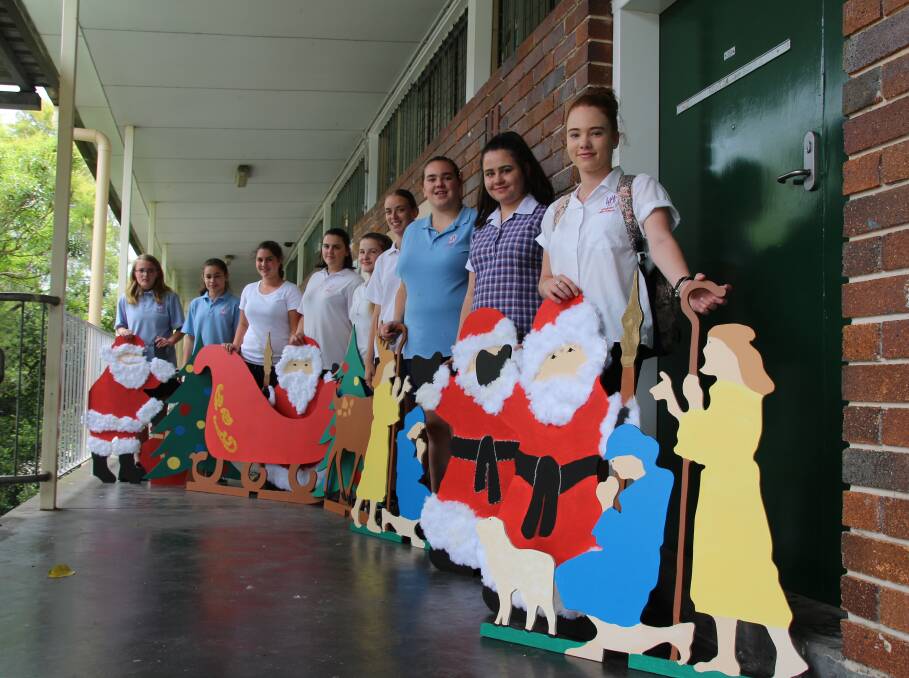 Festive cheer: Some of the students from Wingham High School with the Christmas themed cutouts they painted and decorated ready for display in Wingham CBD. Pictured: Darcie Maddalena, Amber Pereria, Nathalia Anderson, Jessica Gardiner, Laura Morgan Saxby, Jordyn Blanch, Erica Colvin, Taylah McLaughlin, Breana Magee.