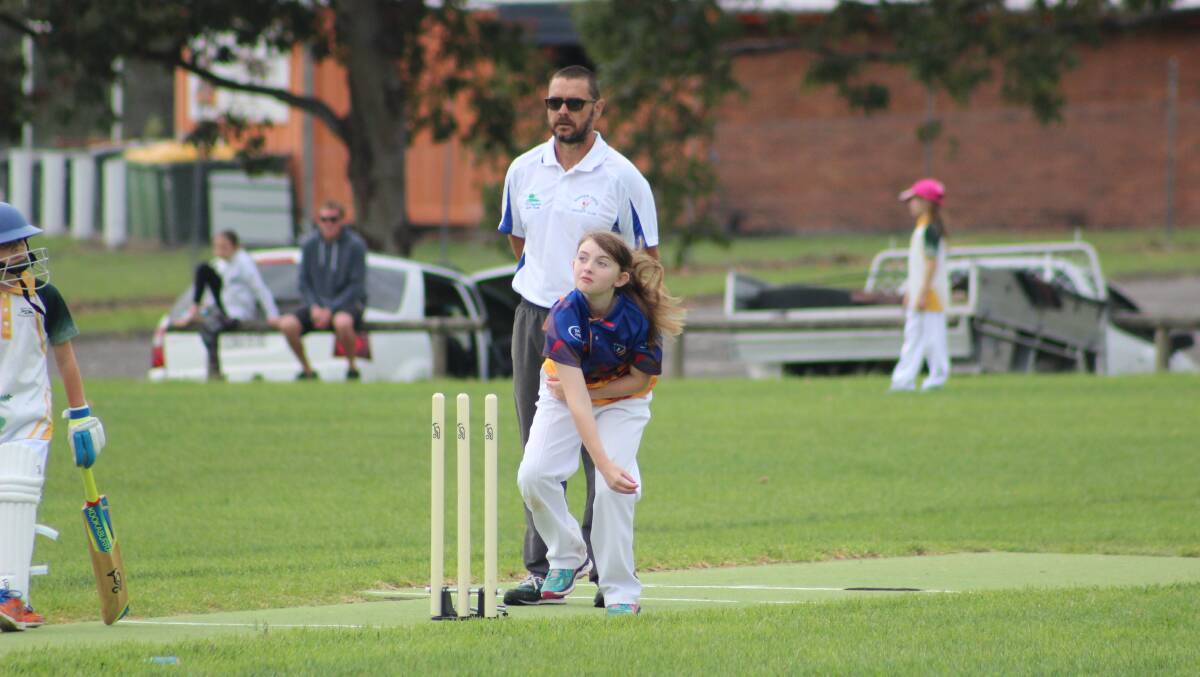 Wingham Under 10 Sixers player Arabella Roohan bowling (2/11, 12 runs) against Forster.