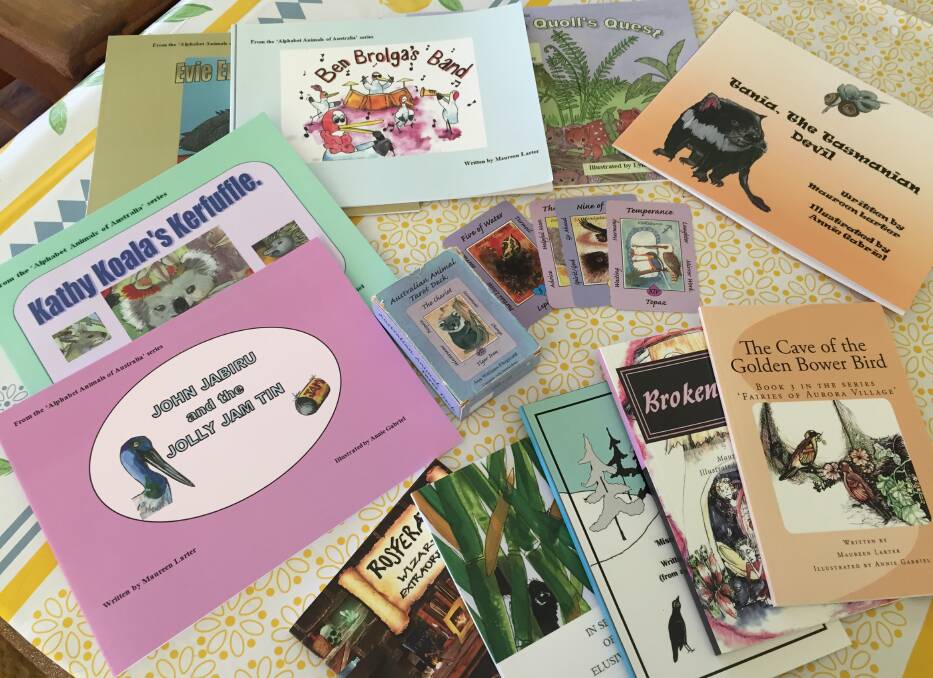 A collection of Maureen's books with the Australian Animal Tarot Deck which has served as a visual inspiration for many of Maureen's stories.