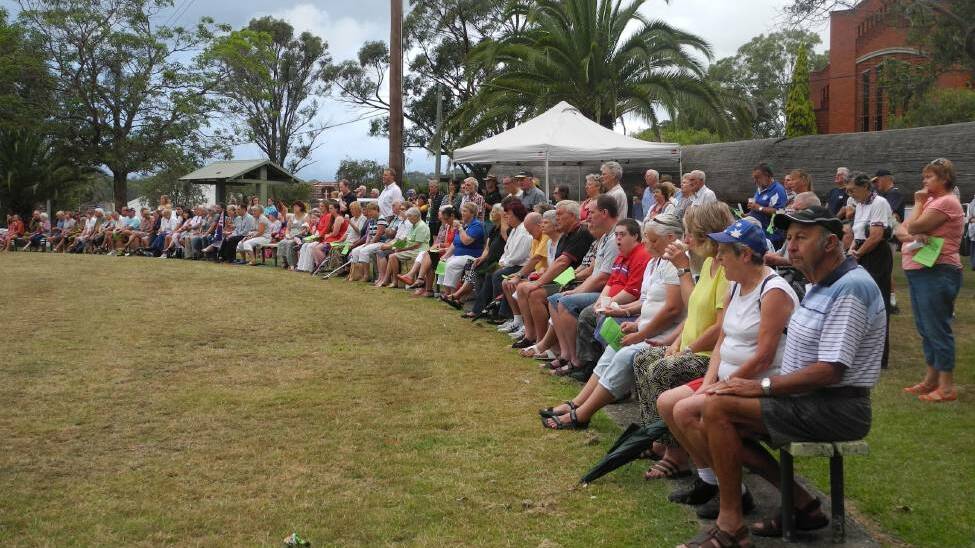 The community gathered by the 'log' in Wingham's Central Park to celebrate Australia Day.