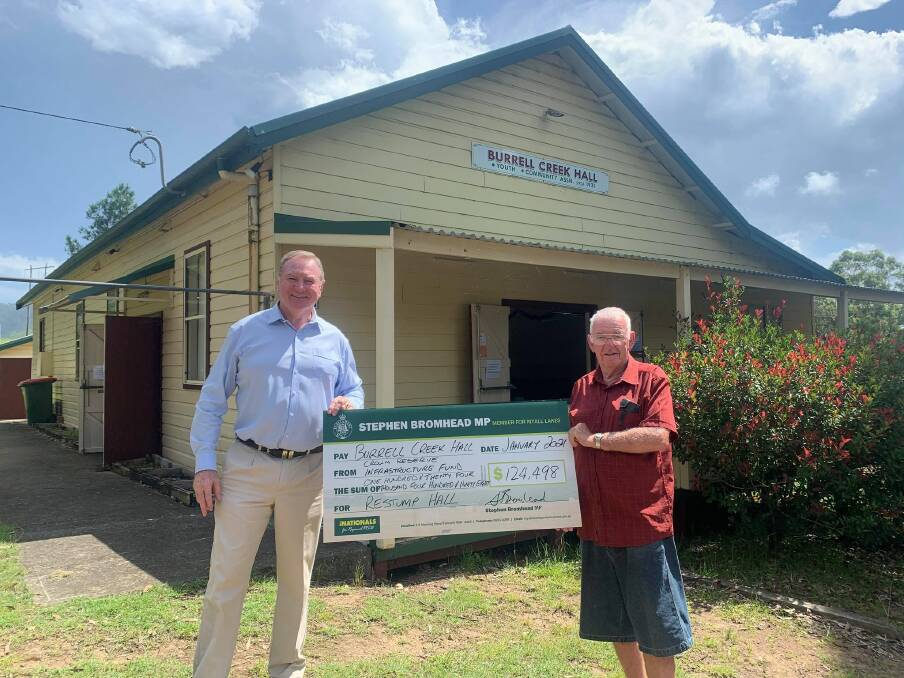 Funding: Stephen Bromhead presenting a cheque for $124,498 to a representative of Burrell Creek Hall. Photo: Supplied