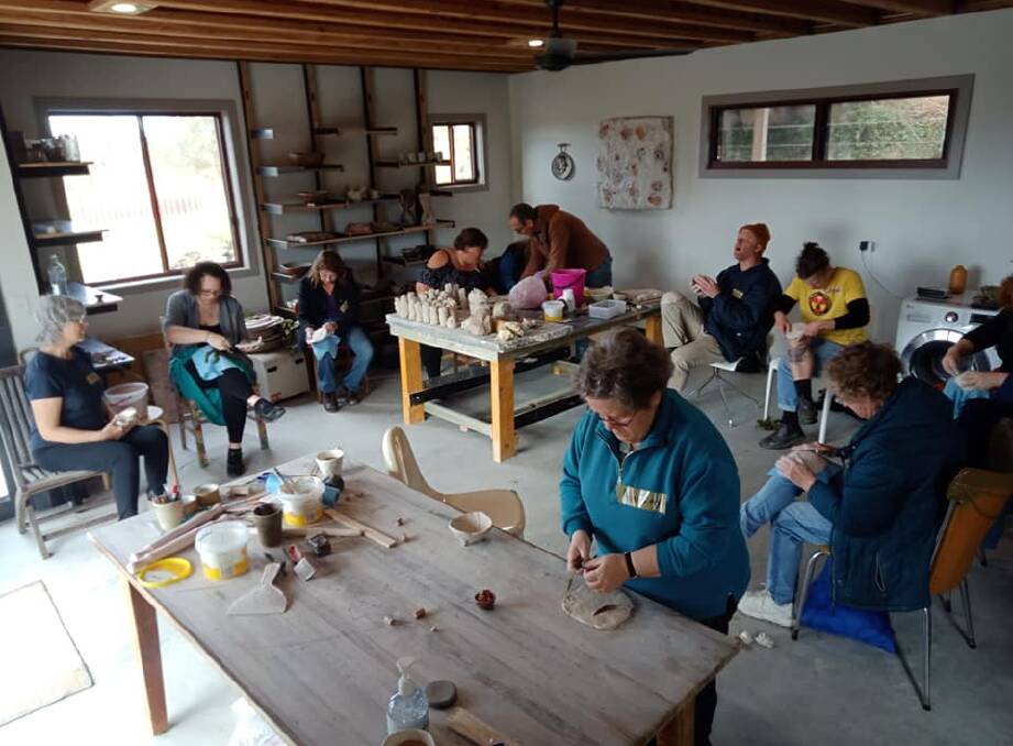 Creating: Bushfire recovery workshop participants creating with clay at Dollys Flat Studio. Photo: Taycee-Lea Jones