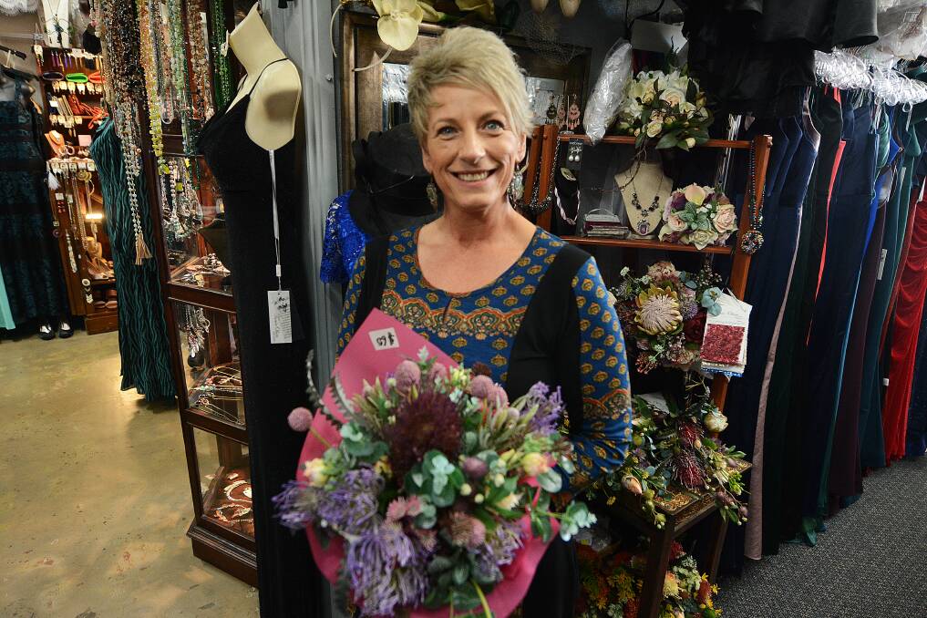 Floral fashions: Wingham fashion store owner Shirley Clarke with one of her floral bouquets. Photo: Scott Calvin