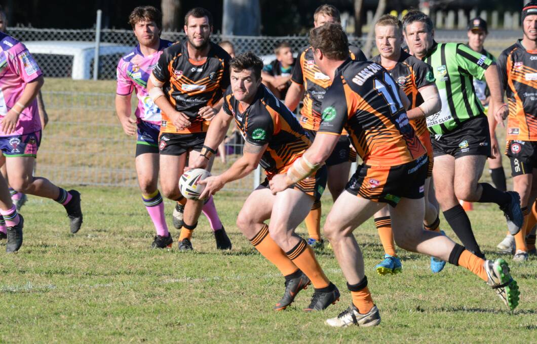 Wingham five-eighth Danny Price offloads during the clash against Taree City at the Jack Neal Oval. Price, with two tries, was named player of the match in Wingham's 30-22 win.