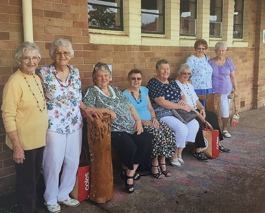 Members of the Wingham CWA check out the new seat in front of their building.