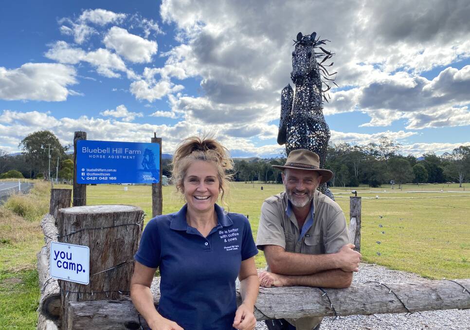 Karen and Ian Gilbert in front of the large horse sculpture which attracts much interest at Bluebell Hill Farm.