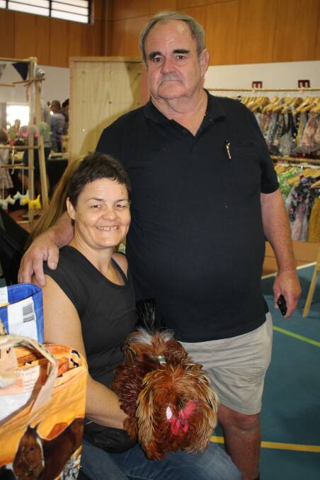 Proud dad John Muxlow with daughter Fiona and her pet rooster Mardi at the Renegade Markets in Townsville.