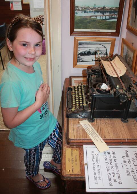 Young Zoe Corner enjoying her visit to Tinonee Museum and ready to have a go on the old typewriter.