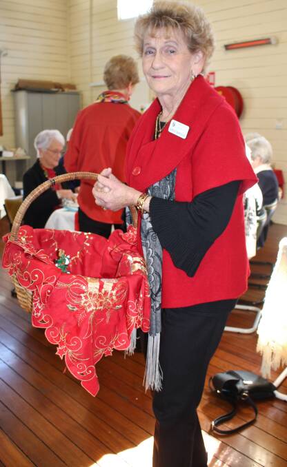 Christmas fare: Wingham Probus member Shirley with the lucky door basket devoid of its goodies after they had all been won.