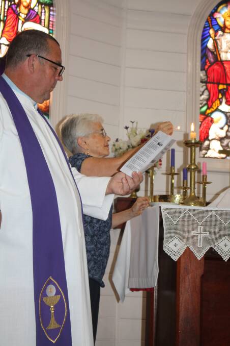 Peace on earth: Lesley Timperley lights the first Advent candle with Rev Brian Ford at St Luke’s Tinonee.
