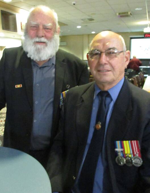 Remembering: Vietnam Veterans from left, Jeff Smith and Graeme Reeve, catch up at Wingham Services Club after Vietnam Veteran's Day service in the Wingham Town Hall.