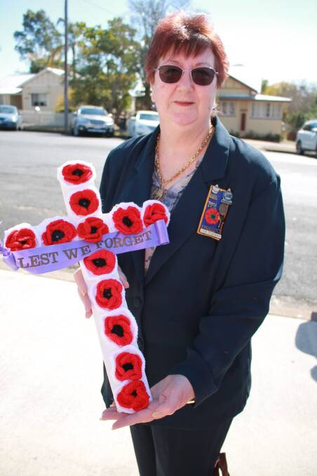 Honour: Lyn Turner of Wingham RSL Sub-branch Auxiliary holds a White Cross (similar design to Long Tan Cross), decorated with hand made peace poppies.