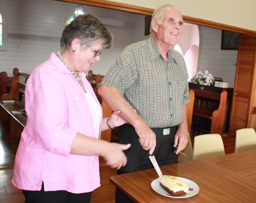 Celebrations: Rhonda Balcombe from Albion Park, with her brother Bryson Muldoon of Tinonee, cutting their 70th birthday cake after church at Tinonee.