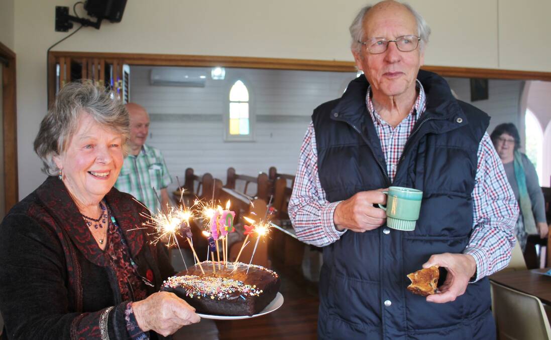 Sue Prentice presenting husband Andrew with his sparkling birthday cake to mark his 80th birthday.