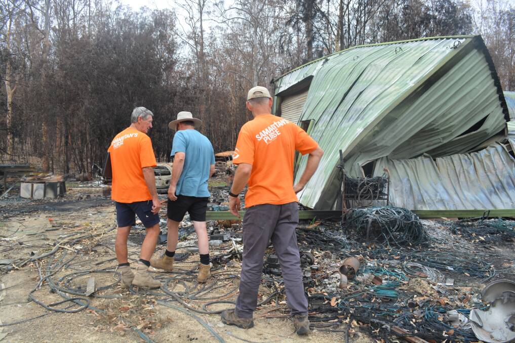 The Samaritan's Purse team of Paul Saurine and Billy Graham Association Chaplain Stewart Beveridge assess the work and tools required to clean-up a local property devastated by fire.