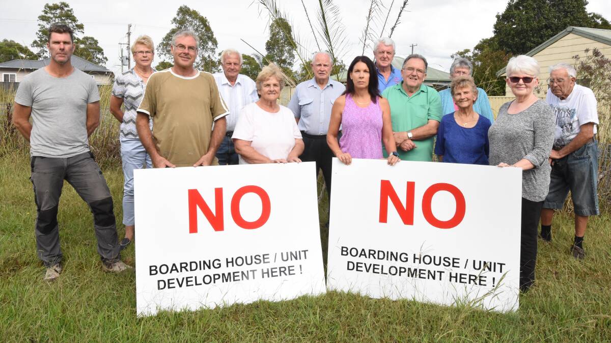 A growing community of residents will unite to fight a proposed Bungalow Homes development that could see boarding houses and units built on one block on Wingham Road. Back row from left is Aaron Casey, Pattie Hogan, Kelvin Smith, Merv Riley, Paul Hogan, Violet Bedford and Norm Bedford. Front row from left is Mark Primmer, Coral Lockrey, Angela Nicholson, Reverend Darrell McKeough, June Riley and Jennifer Kokany.