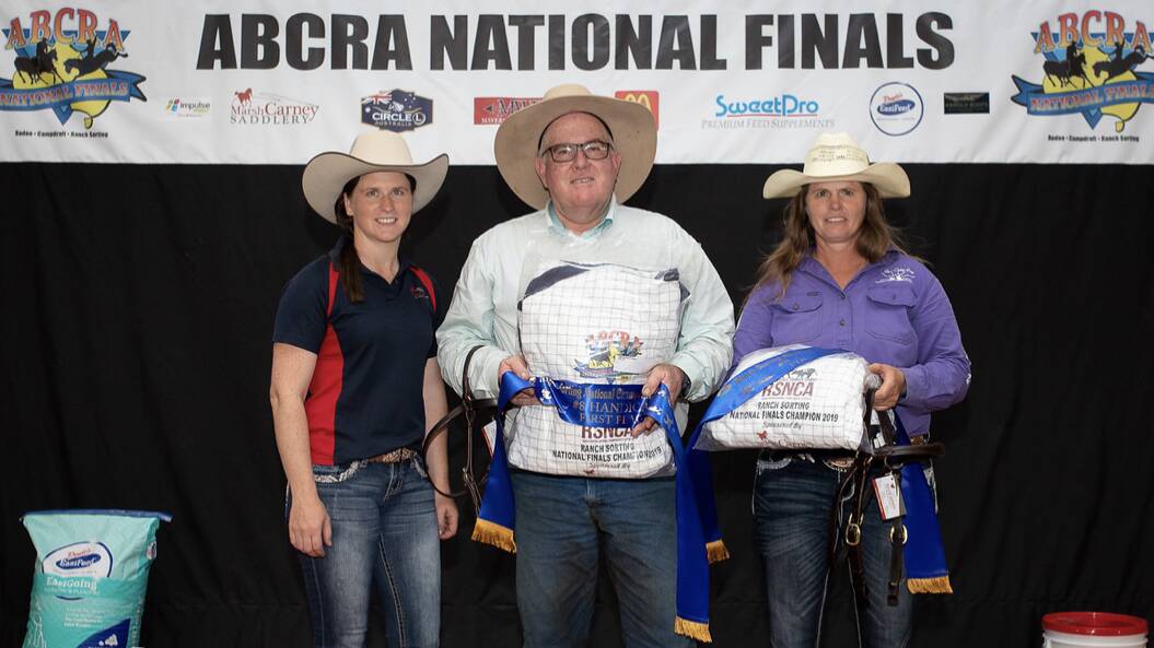 Brian Moore and Stephanie Wooldridge (right) took out the eight handicap class in ranch sorting at the ABCRA National Finals in Tamworth. Pictured with a representative of Marsh Carney Saddlery. Photo supplied