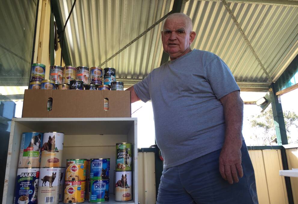 Humbled: John Laidlaw in his 'barn attic' which is completely full of food and essentials for drought stricken farming families (and their dogs). Photo: Julia Driscoll