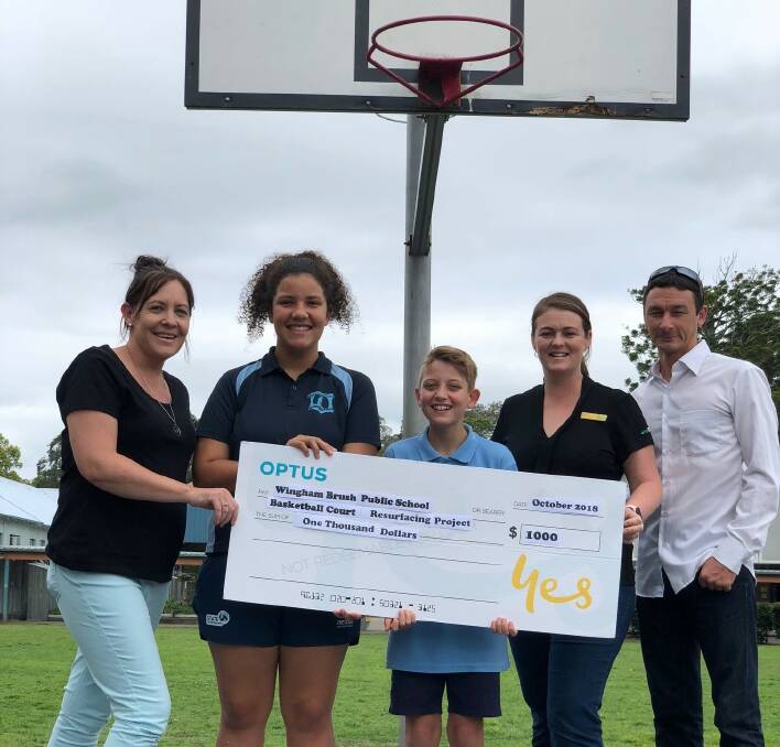 Optus representatives presenting the cheque to the Wingham Brush Public School community. Photo: supplied