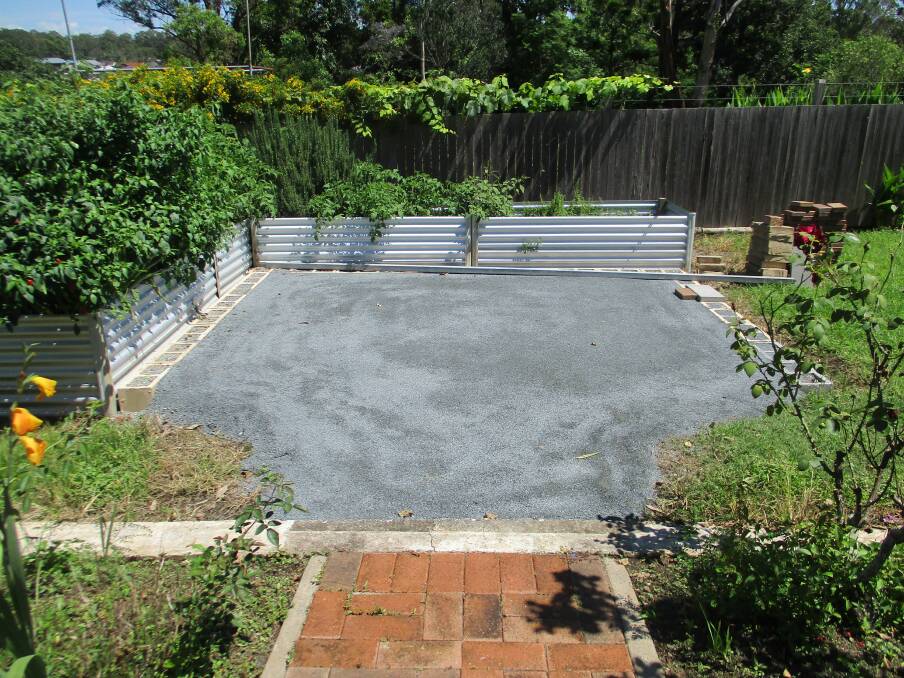 Progress work on the paved area around the garden beds at Tinonee Historical Society garden. Photo Pam Muxlow