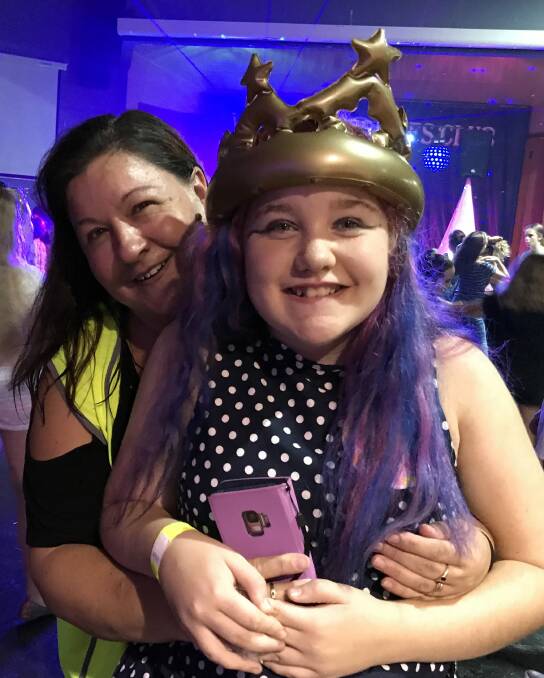 Zarah Mills won the major prize draw at the December Blue Light Disco, pictured with mum, volunteer Michelle Mills. Photo supplied