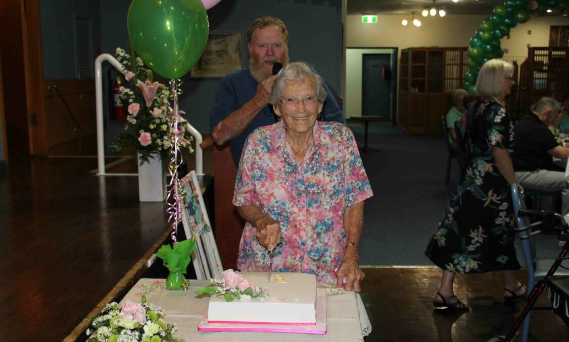 Fran cutting her cake at her 100th birthday celebrations, with son Gary. Photo: submitted