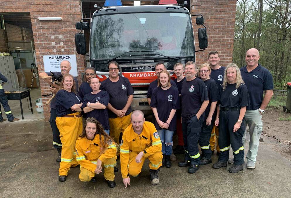 The Krambach RFS crew at their fire station, including the new mascot Jock the kelpie pup.
