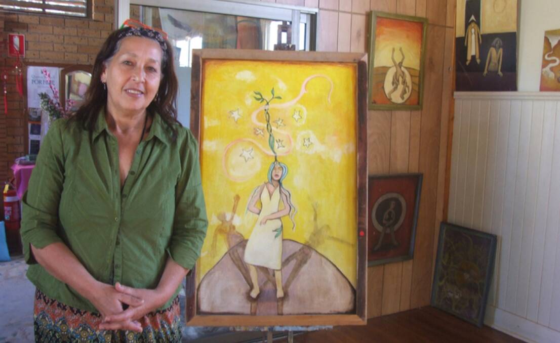 Peggy van Zalm with some of Geoffrey Nant's paintings from the recent tribute exhibition.