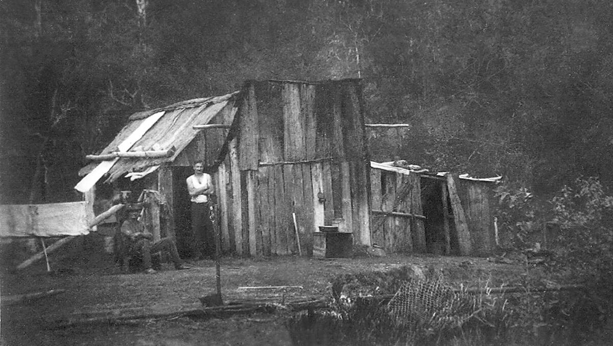 Gold mining: Jim Bugg and Artrhur Hall outside their hut at Mummel River. Constructed of stringy bark, round timber and the odd sheet of galvanished iron. Photo: Manning Valley Historical Society