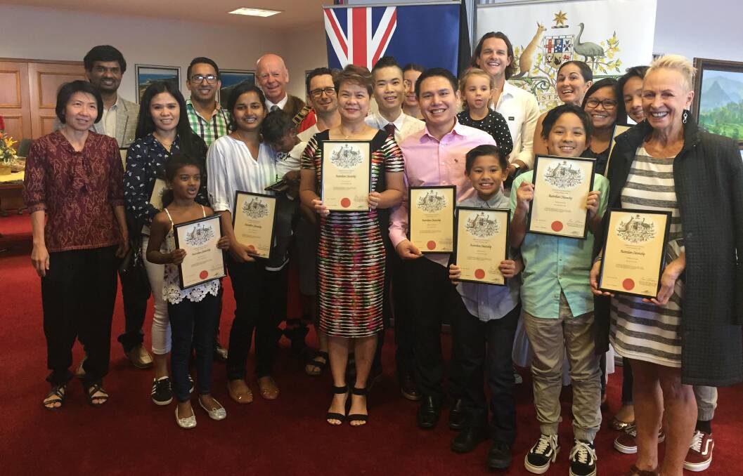 Citizens: Nineteen new Australians and MidCoast Mayor David West following the citizenship ceremony. 