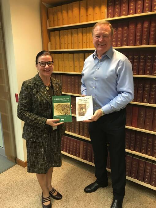Victoria Vaughan-Smith, manager reference services, NSW Parliamentary Library and Member for Myall Lakes Stephen Bromhead in the Library with Margaret Clark's two books. Photo: supplied 