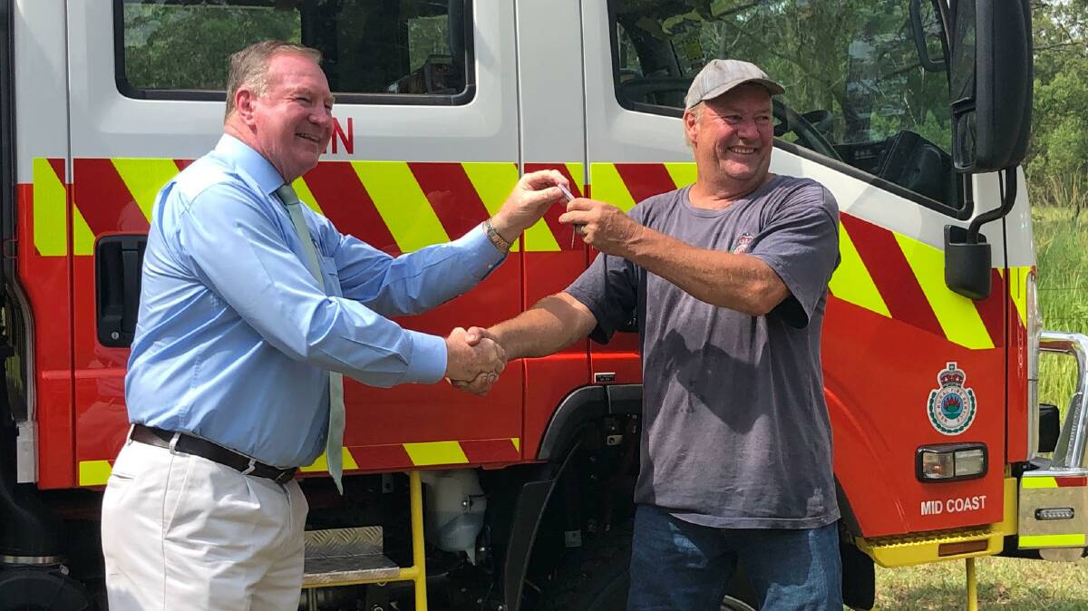 John Howard from Bobin RFS receives the keys to the new vehicle from Member for Myall Lakes, Stephen Bromhead. Photo: supplied