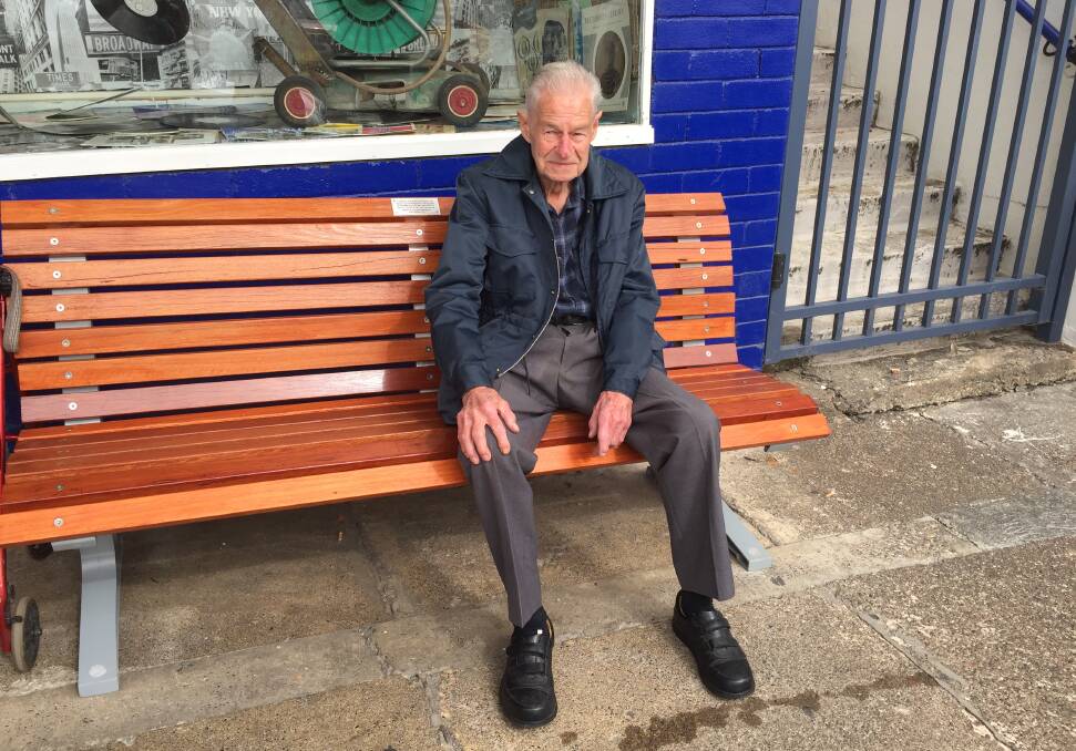 Alan Carlyle OAM, on the seat outside St Vincent de Paul in Isabella Street, Wingham, that was dedicated to him by Rotary in 2017. Photo: Julia Driscoll