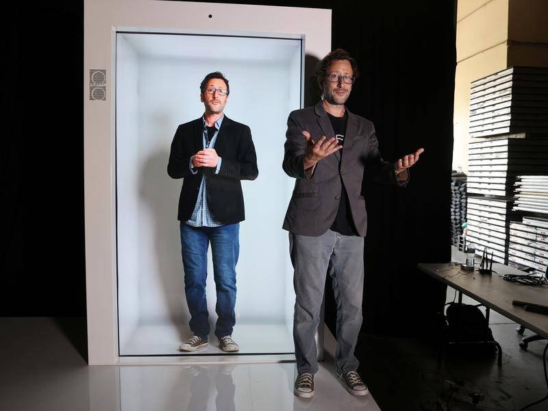 Portl inventor David Nussbaum poses next to an life-size hologram of himself in Los Angeles.