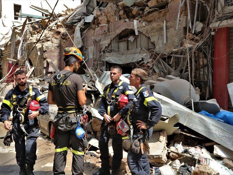 French rescue workers on a wrecked street following a huge blast at Beirut's port.